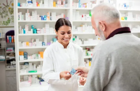 Pharmacist Helping Man with Medication