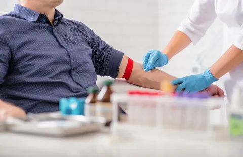 Healthcare professional taking a blood sample from a patient